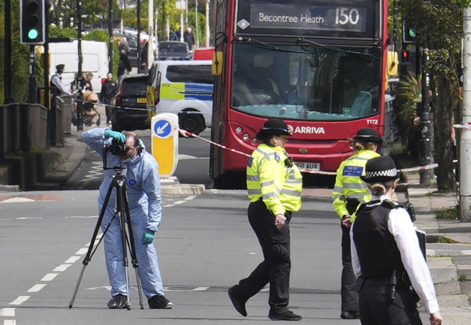 Forensic investigators in Hainault, north east London, Tuesday April 30, 2024. A man wielding a sword attacked members of the public and police officers in a east London suburb, killing a 13-year-old boy and injuring four others, authorities said Tuesday. A 36-year-old man was arrested at the scene, police said. Chief Supt. Stuart Bell said the incident is not being treated as terror-related or a “targeted attack.” (Jordan Pettitt/PA via AP)