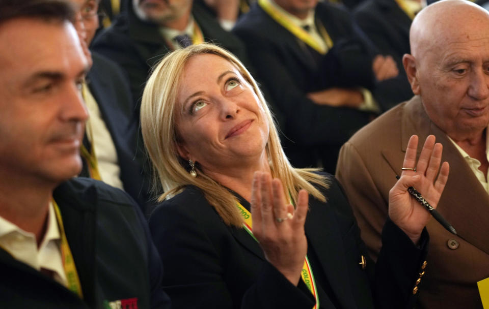 Brothers of Italy leader Giorgia Meloni gestures flanked by Coldiretti Ettore Prandini, left, prior to speaks during an Italian farmers association's event, at the Sforzesco Castle in Milan, Italy, Saturday, Oct. 1, 2022. (AP Photo/Luca Bruno)