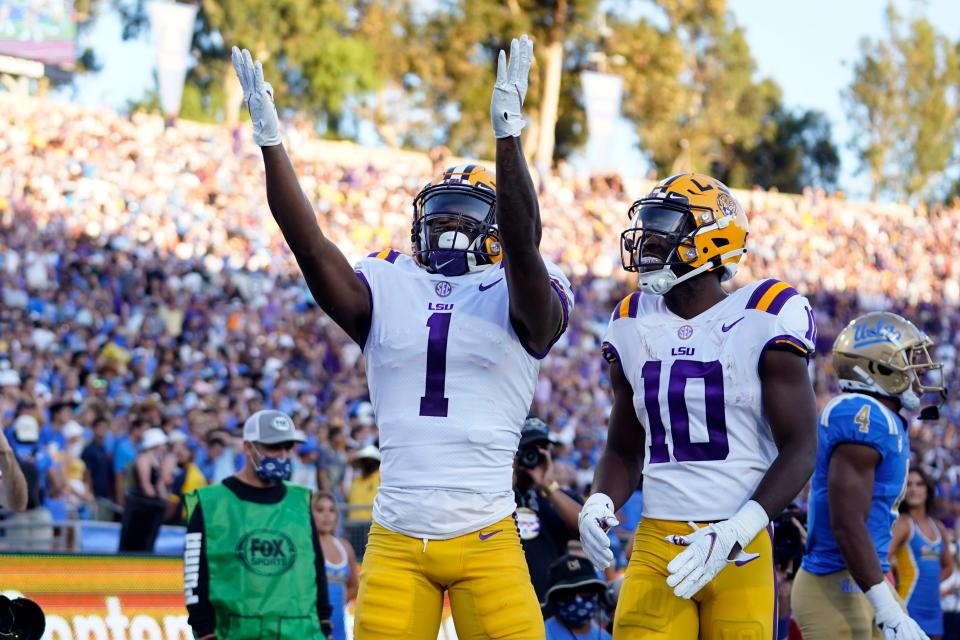 LSU wide receiver Kayshon Boutte (1) celebrates his touchdown catch with wide receiver Jaray Jenkins (10) during the first half against UCLA on Saturday, Sept. 4, 2021, in Pasadena, Calif.