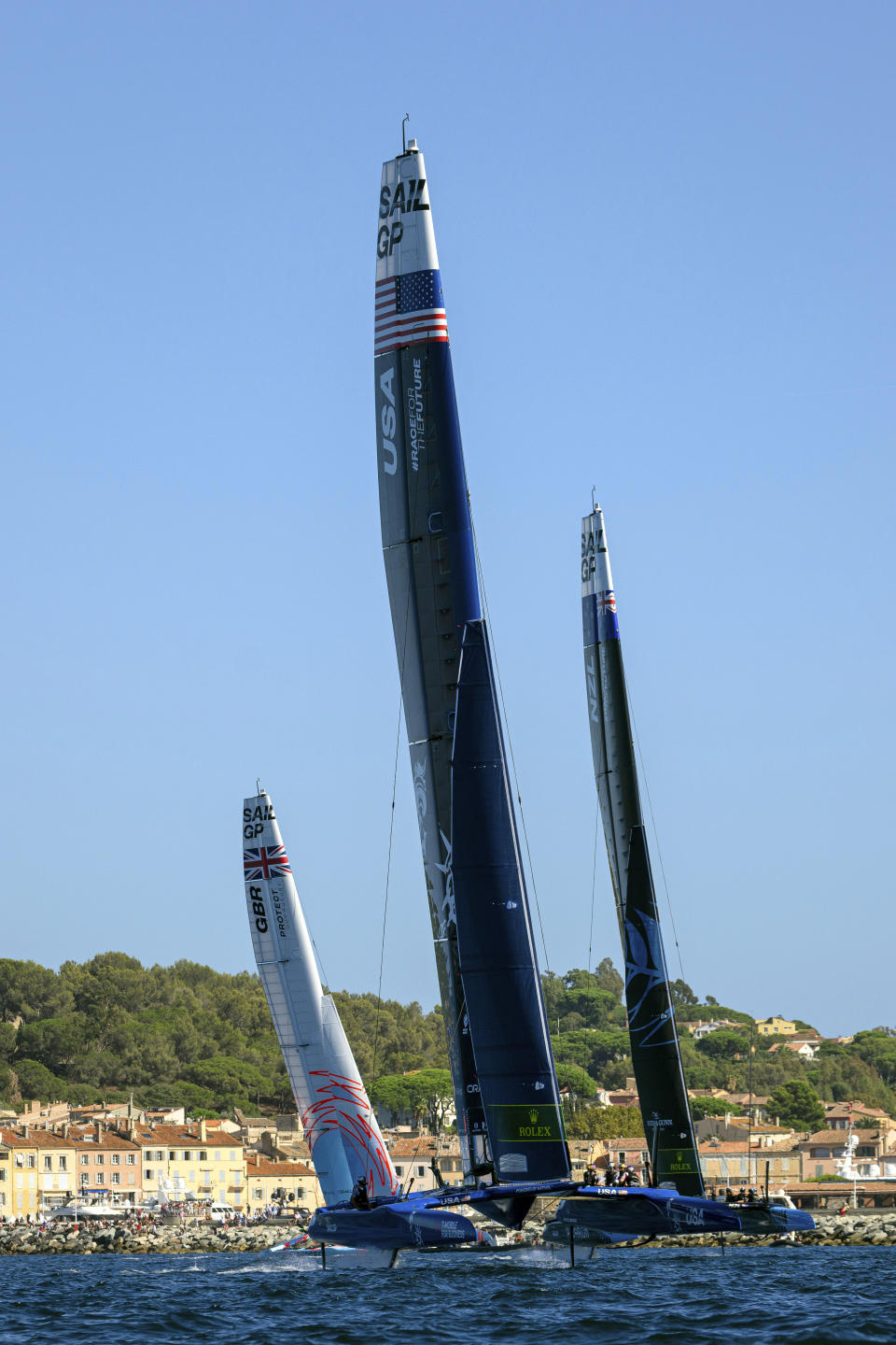 Great Britain SailGP Team helmed by Ben Ainslie, USA SailGP Team helmed by Jimmy Spithill and New Zealand SailGP Team helmed by Peter Burling in action on Race Day 2 of the Range Rover France Sail Grand Prix in Saint Tropez, France, Sunday, Sept. 11, 2022. (Ricardo Pinto/SailGP via AP)