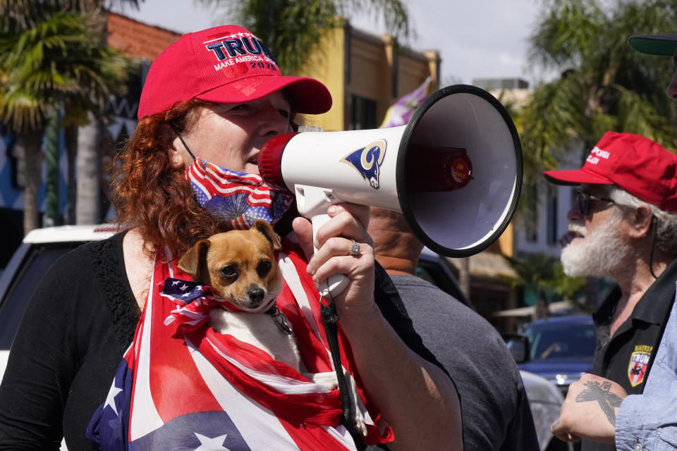 A protester demonstrates against stay-at-home orders that were put in place due to the COVID-19 outbreak, Friday, April 17, 2020, in Huntington Beach, Calif. (AP Photo/Mark J. Terrill)