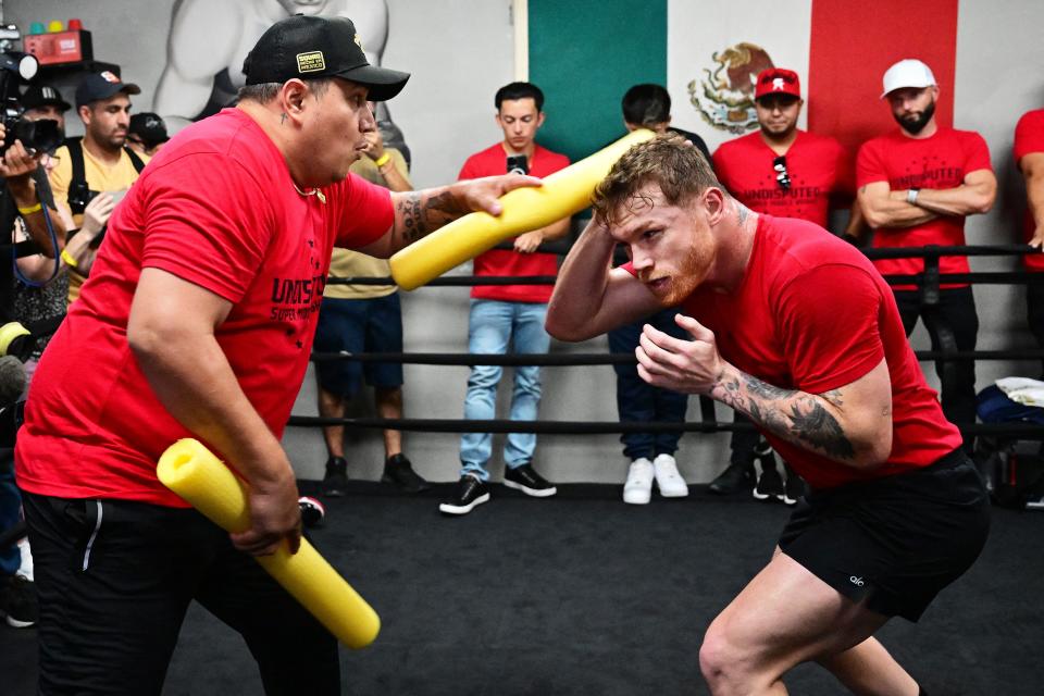 Mexican professional boxer Canelo Alvarez (R) trains during a media gathering at House of Boxing in San Diego, California, on August 29, 2022, ahead of his trilogy showdown with Kazakhstani professional boxer Gennadiy 'GGG' Golovkin in September in Las Vegas. - Alvarez is training ahead of a trilogy showdown with Kazakhstani professional boxer Gennadiy GGG Golovkin, which will take place in Las Vegas on September 17, 2022. (Photo by Frederic J. BROWN / AFP) (Photo by FREDERIC J. BROWN/AFP via Getty Images)