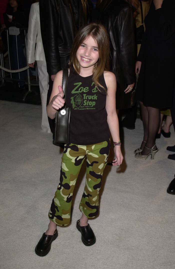 Emma smiling in camo capri pants and sleeveless T-shirt