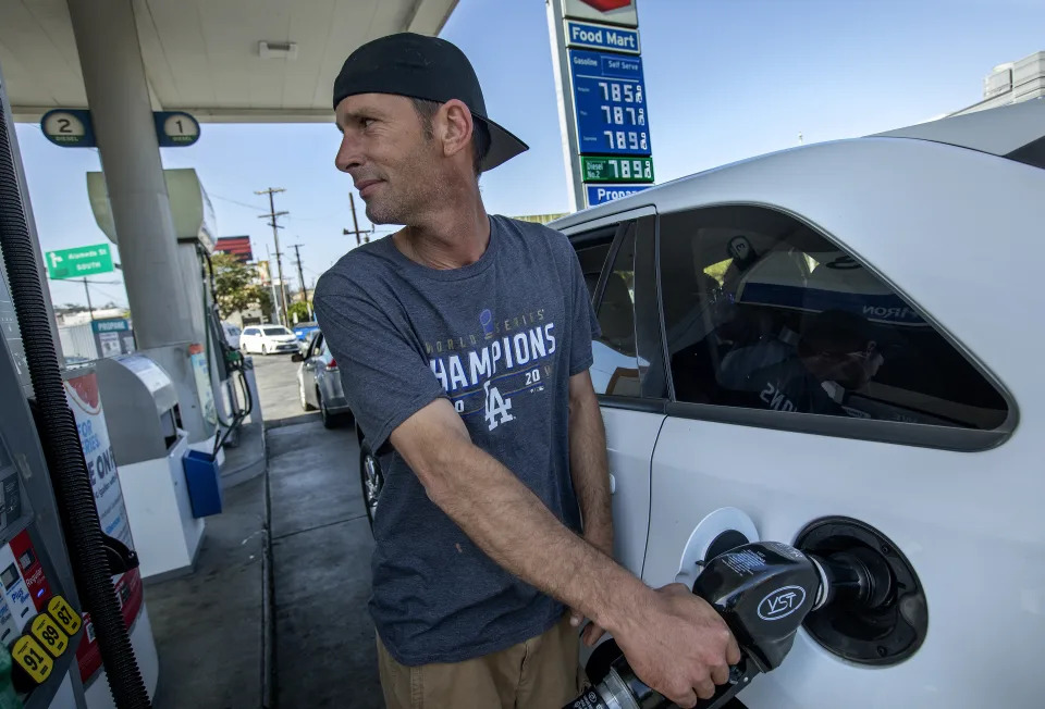 LOS ANGELES, CA-JUNE 1, 2022: Richard Thomas, 41, of Fontana, pays close attention to how many gallons of gas he is buying while filling up his nearly empty tank at the Chevron gas station, located at the intersection of Cesar. E. Chavez Ave. and Alameda Street in downtown Los Angeles. The price of gas at this station is almost $8 a gallon. Thomas said that he forgot to fill up back in Fontana, and drove down to Los Angeles to attend the Los Angeles Dodgers baseball game. He ended up buying 3 gallons of gas, just enough to get back home after the game. (Mel Melcon / Los Angeles Times via Getty Images)