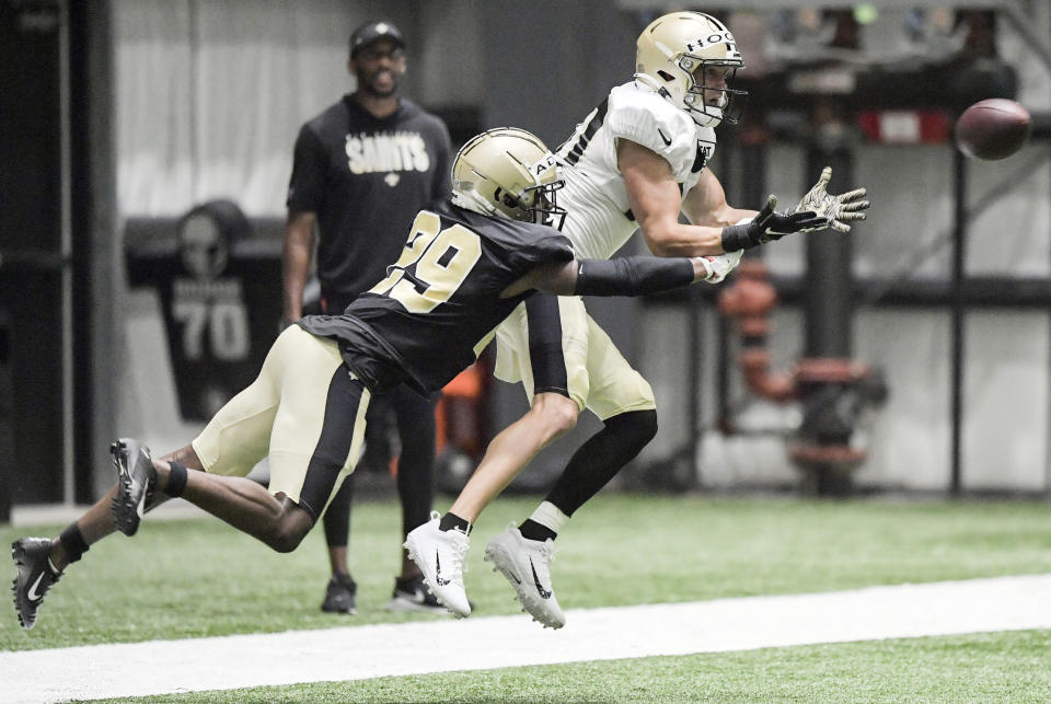 New Orleans Saints wide receiver Chris Hogan (80) catches the ball under pressure from cornerback Paulson Adebo (29) during NFL football practice, Thursday, Aug. 12, 2021, in Metairie, La. (Max Becherer/The Times-Picayune/The New Orleans Advocate via AP)