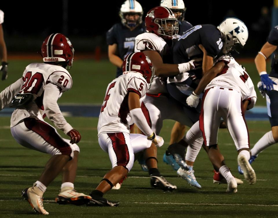 Brockton's Tsunami Rezende (74) combined with Cam Monteiro (1) on the tackle during a game against Franklin on Friday, September 16, 2022. The Boxers lost, 37-6.