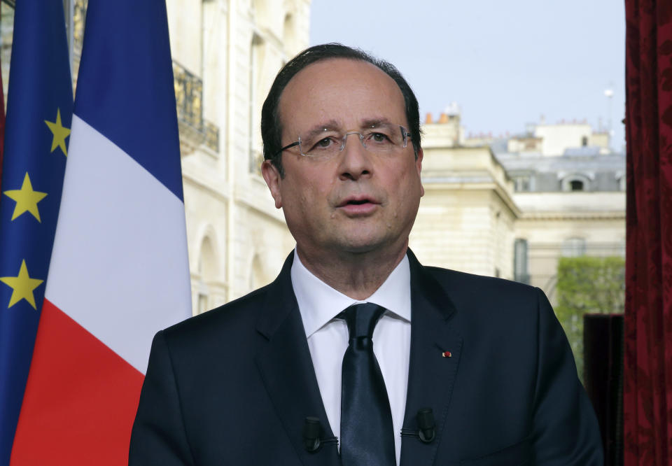 French President Francois Hollande delivers his speech which was pre-recorded, and broadcast on French television, at the Elysee Palace, in Paris, on Monday March 31, 2014. Hollande has named 51-year-old Socialist Manuel Valls as the country's new prime minister. France's government resigned Monday and President Hollande named Valls, just 24 hours after his Socialists suffered heavy losses in nationwide municipal elections. (AP Photo/Philippe Wojazer, Pool)