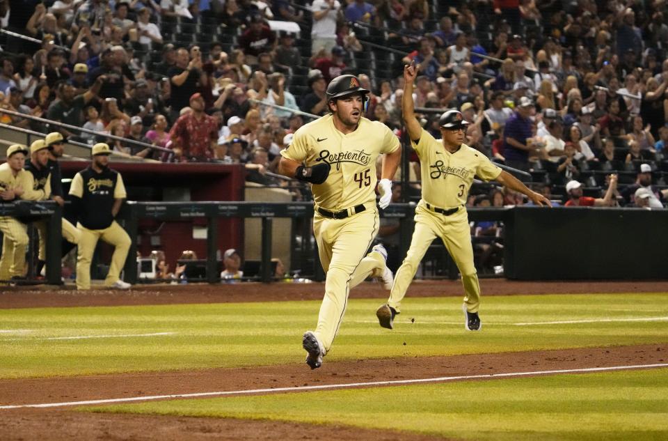 Jun 17, 2022; Phoenix, Arizona, USA; Arizona Diamondbacks Buddy Kennedy (45) scores on a throwing error by Minnesota Twins pitcher Devin Smeltzer (31) in the fourth inning at Chase Field.