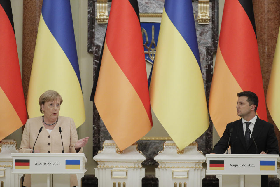 Ukrainian President Volodymyr Zelenskyy, right, and German Chancellor Angela Merkel attend a joint news conference following their talks at the Mariinsky palace in Kyiv, Ukraine, Sunday, Aug. 22, 2021. German Chancellor Angela Merkel arrived to Kyiv for a working visit to meet with top Ukrainian officials. (Sergey Dolzhenko/Pool Photo via AP)
