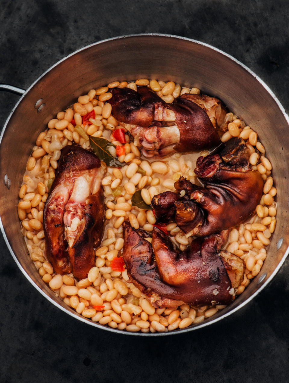 Isaac Toups suggests cooking trotters in beans, which soak up their rich flavor. (Photo: Denny Culbert)