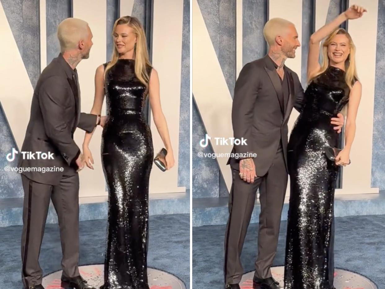 Adam Levine and Behati Prinsloo posing on at the Vanity Fair Oscars party.