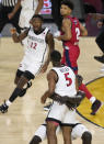 San Diego State forward Aguek Arop picks up teammate guard Lamont Butler (5) after Butler hit the winning shot against Florida Atlantic during the second half of a Final Four college basketball game in the NCAA Tournament on Saturday, April 1, 2023, in Houston. (AP Photo/Godofredo A. Vasquez)