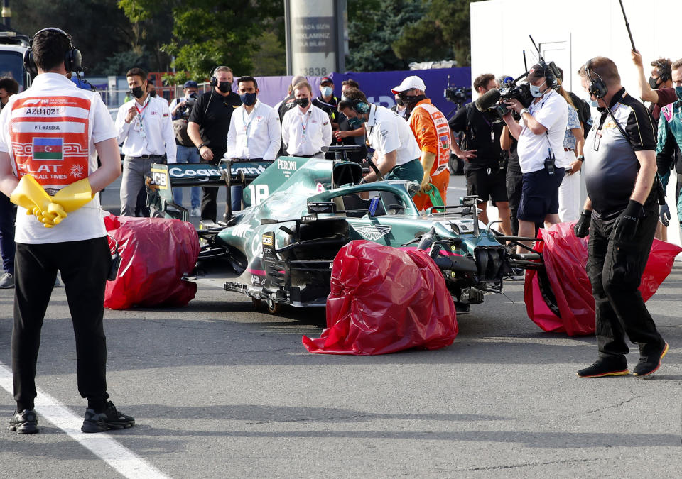 The car of Aston Martin driver Lance Stroll of Canada sits with its wheels wrapped after a crash during the Formula One Grand Prix at the Baku Formula One city circuit in Baku, Azerbaijan, Sunday, June 6, 2021. (Maxim Shemetov, Pool via AP)