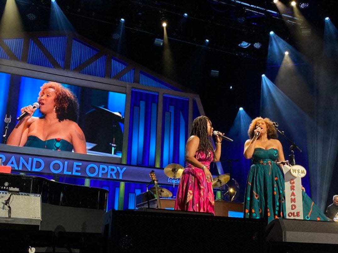 Rissi Palmer and Miko Marks appear onstage together at the Grand Ole Opry on Aug. 12, 2022