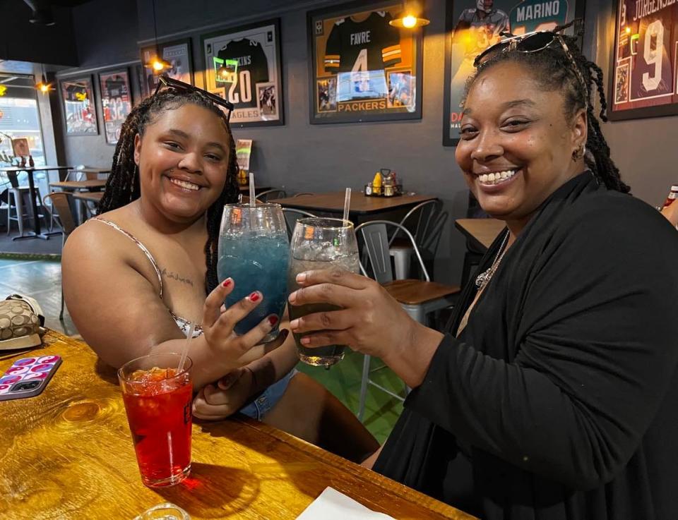Makayla Williams and Ariel Morgan enjoy drinks at Gridiron Pizza & Sports Bar in downtown Canton. The cocktails were made by bartender Jamal Gomez, who has created a new drink menu for the restaurant.