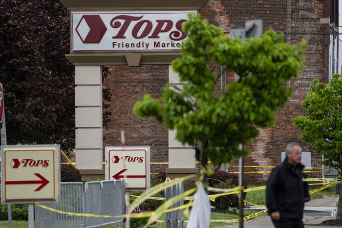 People gather at the scene of a mass shooting at a Tops Friendly Market on May 16, 2022, in Buffalo, New York.