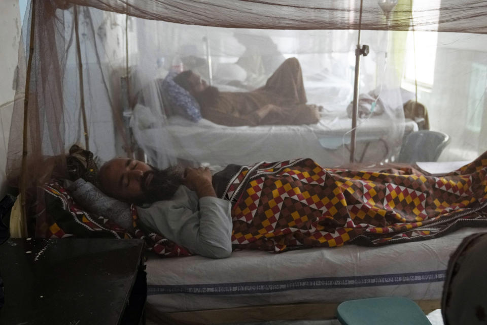 Pakistani patients suffering from dengue fever, a mosquito-borne disease, are treated in an isolation ward, at a hospital in Lahore, Pakistan, Friday, Sept. 23, 2022. Pakistan has deployed thousands of additional doctors and paramedics in the country's worst flood-hit province to contain the spread of diseases that have killed over 300 people among the flood victims, officials said Friday. (AP Photo/K.M. Chaudary)