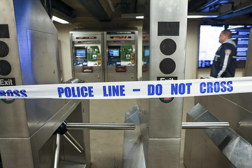 New York Police walk through the Mount Eden subway station while investigating a shooting, Monday, Feb. 12, 2024, in the Bronx borough of New York. Several people were shot Monday at the New York City subway station, police said. (New York Police Department via AP)