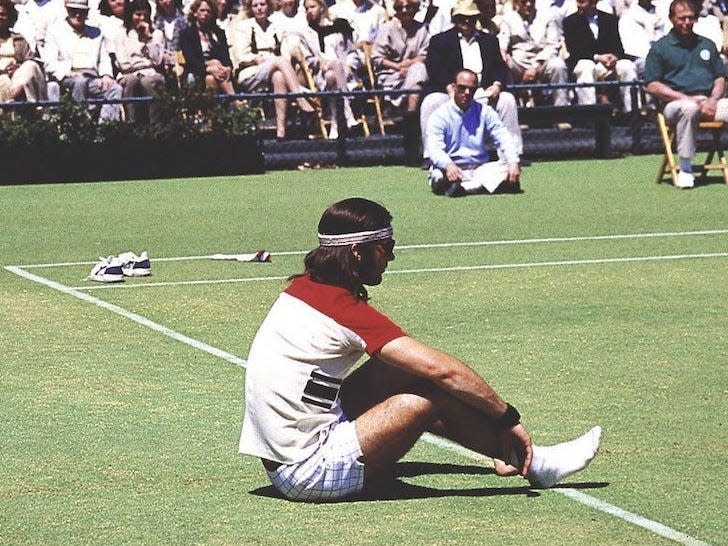 Richie Tenenbaum (Luke Wilson) sits dejectedly on a tennis court in front of a crowd of onlookers in this scene from "The Royal Tenenbaums."