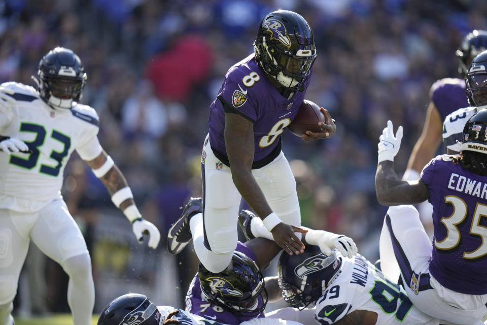 Baltimore Ravens quarterback Lamar Jackson (8) leaps over Seattle Seahawks defensive end Leonard Williams (99) during the first half of an NFL football game, Sunday, Nov. 5, 2023, in Baltimore. (AP Photo/Alex Brandon)