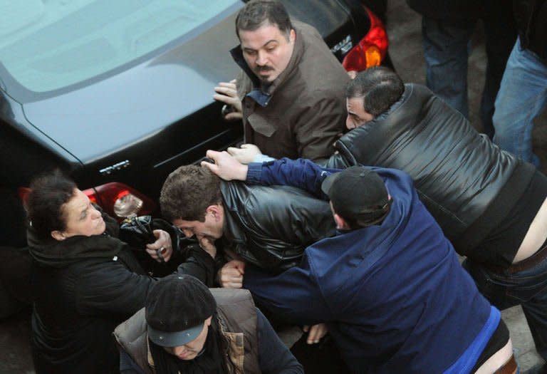 Georgian President Mikheil Saakashvili's allies scuffles with protesters in Tbilisi , on February 8, 2013