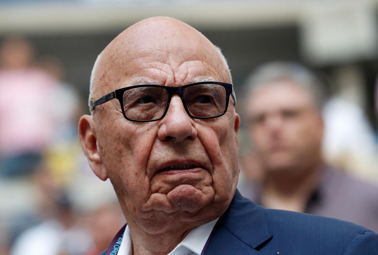 Rupert Murdoch turns his head, looking aggrieved.