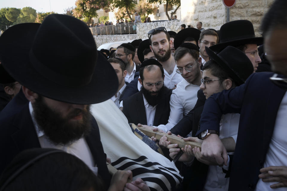 Mourners carry the body of 16-year-old Aryeh Shechopek, a dual Israeli-Canadian citizen, during his funeral in Jerusalem, Wednesday, Nov. 23, 2022. Two blasts have gone off near bus stops in Jerusalem, killing Shechopek and injuring at least 18, in what Israeli police said were suspected attacks by Palestinians. (AP Photo/Maya Alleruzzo)