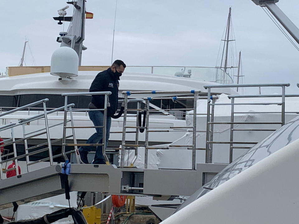 A U.S. Homeland Security Police (HSI) agent climbs on board the Tango superyacht, suspected to belong to a Russian oligarch, as it is docked at the Mallorca Royal Nautical Club in Palma de Mallorca, in the Spanish island of Mallorca, Spain, April 4, 2022. Juan Poyates Oliver/Handout via REUTERS  THIS IMAGE HAS BEEN SUPPLIED BY A THIRD PARTY. MANDATORY CREDIT