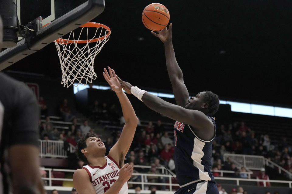 Arizona center Oumar Ballo, right, drives to the basket against Stanford forward Brandon Angel, left, during the first half of an NCAA college basketball game, Sunday, Dec. 31, 2023, in Stanford, Calif. (AP Photo/Tony Avelar)