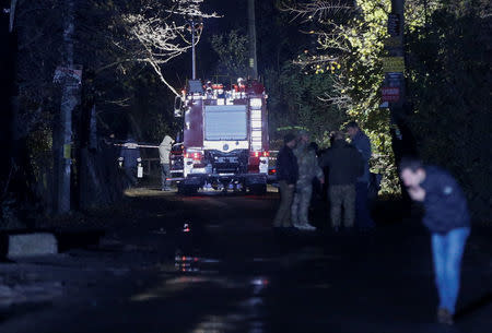 Investigators work at the site where Amina Okuyeva, the wife of a Chechen man accused by Russia of plotting to kill President Vladimir Putin, was shot dead in the town of Hlevakha, Ukraine October 30, 2017. Picture taken October 30, 2017. REUTERS/Valentyn Ogirenko