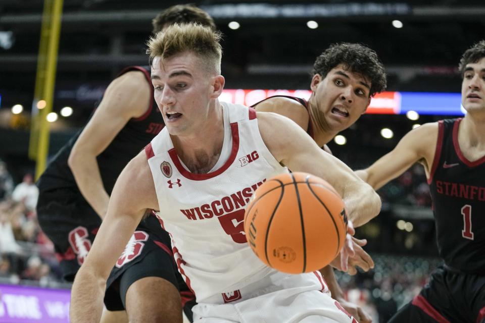 Wisconsin's Tyler Wahl drives past Stanford's Brandon Angel during the first half of an NCAA college basketball game Friday, Nov. 11, 2022, in Milwaukee. The game is being played at American Family Field, home of the Milwaukee Brewers. (AP Photo/Morry Gash)