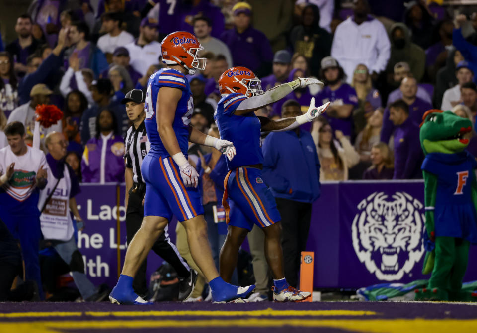Florida running back Trevor Etienne, center right, celebrates after a touchdown against LSU during the second half of an NCAA college football game in Baton Rouge, La., Saturday, Nov. 11, 2023. (AP Photo/Derick Hingle)