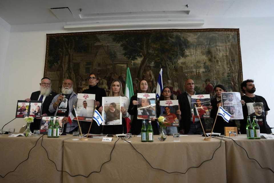 Relatives of Israeli hostages being held by Hamas, from left, Bezalel Schneider, Dani Miran, Naama Miran, Ashley Waxman Bakshi, Li-Yam Berger, Amit Nimrodi, Alon Nimrodi Meirav Gilboa-Dalal, and Gal Gilboa-Dalal, pose with photos of the kidnapped before a press conference in Rome, Monday, April 8, 2024. Pope Francis met Monday with relatives of hostages taken by Hamas on Oct. 7, marking the six-month anniversary of the attack in southern Israel with an hourlong audience. (AP Photo/Alessandra Tarantino)