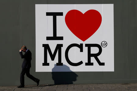 A man walks past a sign in central Manchester, Britain May 25, 2017. REUTERS/Stefan Wermuth