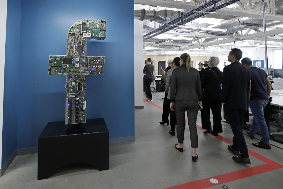 In this Jan. 9, 2019 photo, media and guests tour Facebook's new 130,000-square-foot offices, which occupy the top three floors of a 10-story Cambridge, Mass. building. The space gives the company room to triple its current local staff of more than 200. The Silicon Valley company, created by Mark Zuckerberg when he was two subway stops away at Harvard University, opened its first Boston office five years ago. (AP Photo/Elise Amendola)