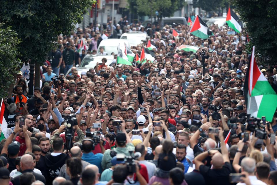 In Ramallah in the West Bank, people, holding flags and shouting slogans, gather for a protest against yesterday's explosion at the Al-Ahli Baptist Hospital that Hamas blames on Israel, and Israel blames on the Palestinian Islamic Jihad. (Photo by Issam Rimawi/Anadolu via Getty Images)