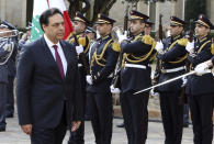 This photo released by the Lebanese Government, Lebanese Prime Minister Hassan Diab, left, reviews an honor guard during a ceremony held on his first day at the Government House in Beirut, Lebanon, Wednesday, Jan. 22, 2020. A new Cabinet was announced in crisis-hit Lebanon late Tuesday, breaking a months-long impasse amid mass protests against the country's ruling elite and a crippling financial crisis, but demonstrations and violence continued. (Dalati Nohra/Lebanese Government via AP)