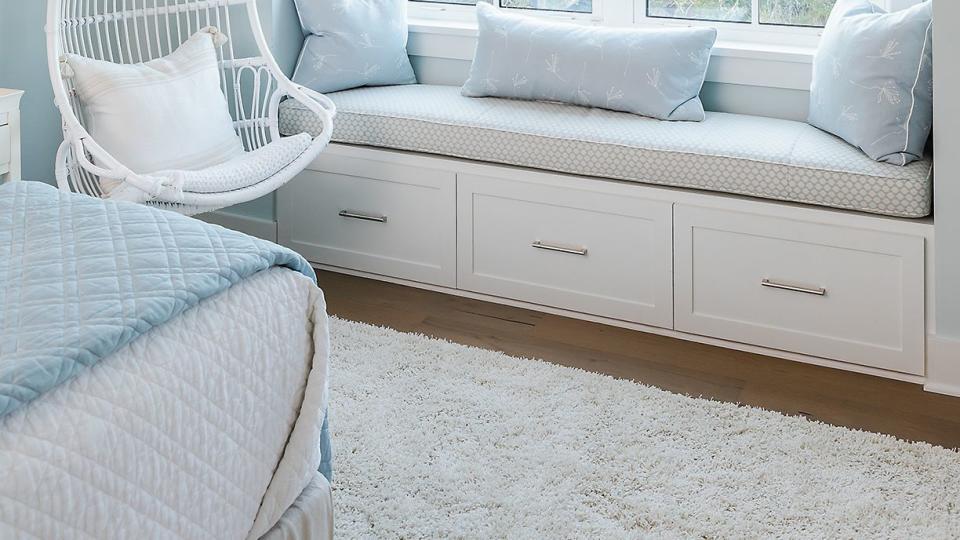 bedroom with blue curtains and window seat