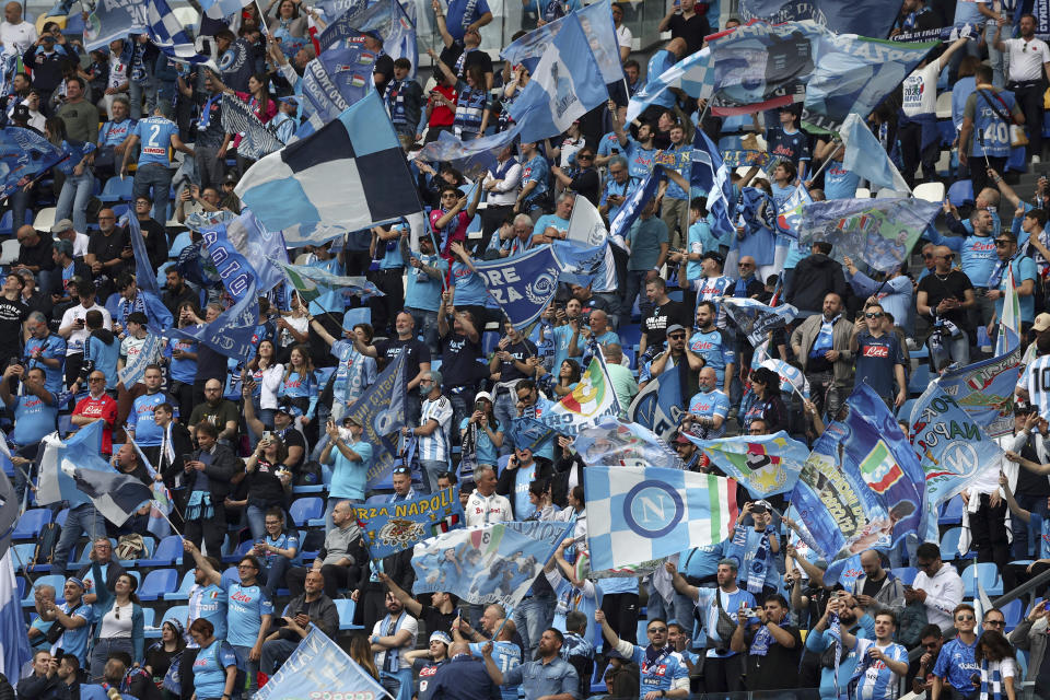 Napoli fans celebrate as they wait for the start of the Serie A soccer match between Napoli and Salernitana, at Naples' Diego Armando Maradona stadium, Italy, Sunday, April 30, 2021. Napoli fans are already celebrating in anticipation of sealing the club’s first Italian league title since the days when Diego Maradona played for the club. Hours before Napoli’s match against Salernitana later Sunday, fans waved flags in Italy’s green, white and red colors that featured a “3” on them to signify what would be the team’s third Serie A championship after Maradona led the Partenopei to their first two titles in 1987 and 1990. (Alessandro Garofalo/LaPresse via AP)