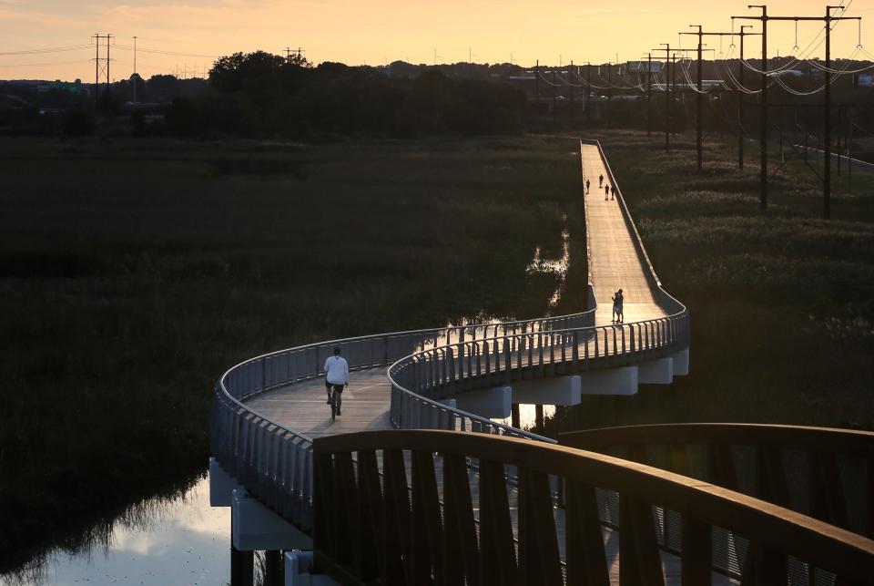 A bicyclist passes the DuPont Environmental Education Center on the Jack A. Markell Trail in Wilmington.