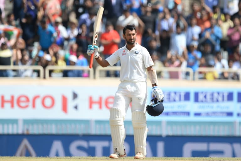 India's batsman Cheteshwar celebrates his century during the third day of the third Test against Australia in Ranchi, on March 18, 2017