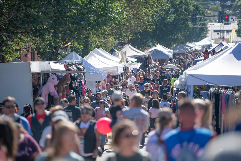 Spectators walk the length of Union Ave. in downtown Pueblo during the 28th Annual Chile and Frijoles Festival on Saturday, Sept. 24, 2022.