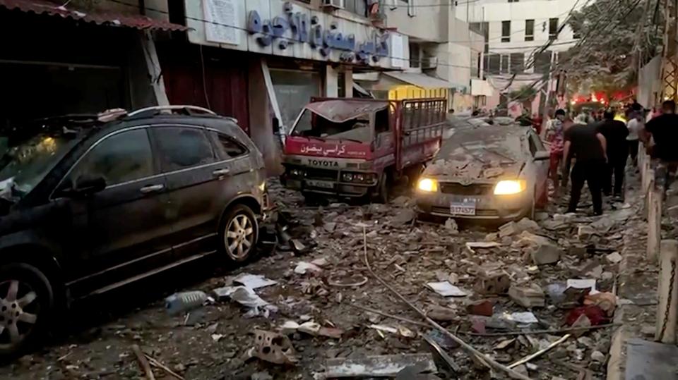 Damaged vehicles are seen after an Israeli strike on Beirut's southern suburbs on July 30 in this screen grab from a video.