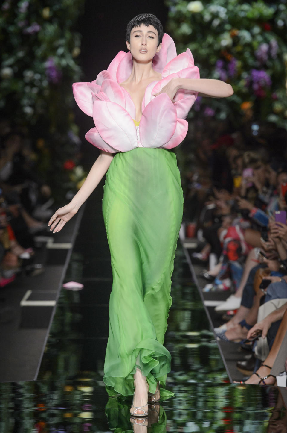 <p><i>Anna Cleveland wears a pink petal bodice and green dress from the SS18 Moschino collection. (Photo: ImaxTree) </i></p>