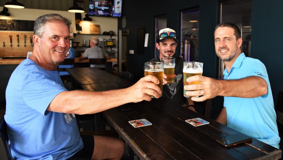 From left, John Gilkison, Jeff Ripper and Jim Allen enjoy beers at Smithville Brewing Company.