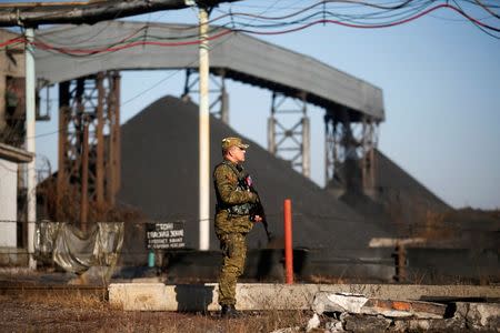 A pro-Russian separatist stands guard at coal mine number 22 "Kommunar" in the village of Nizhnyaya Krynka, east from Donetsk, November 6, 2014. REUTERS/Maxim Zmeyev