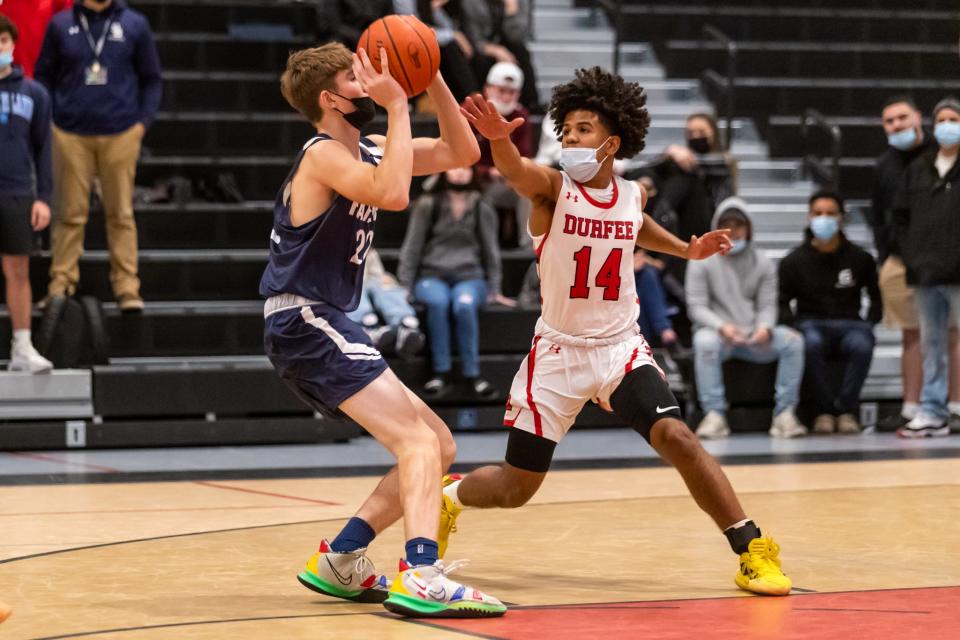 Durfee’s Jeyden Espinal cuts off the lane from Somerset Berkley’s Drew McGarry during an earlier game at B.M.C. Durfee High School.