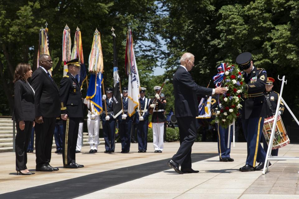 US President Joe Biden (C) participates in a wreath-laying ceremony as part of a Memorial Day observance, as US Vice President Kamala Harris (L) and US Secretary of Defense Lloyd Austin (2-L) look on, at Tomb of the Unknown Soldier at Arlington National Cemetery, in Arlington, Virginia, USA, 30 May 2022.