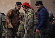 Fighters from the Syrian Democratic Forces (SDF) are seen together in the village of Baghouz, Deir Al Zor province, Syria February 18, 2019. REUTERS/Rodi Said