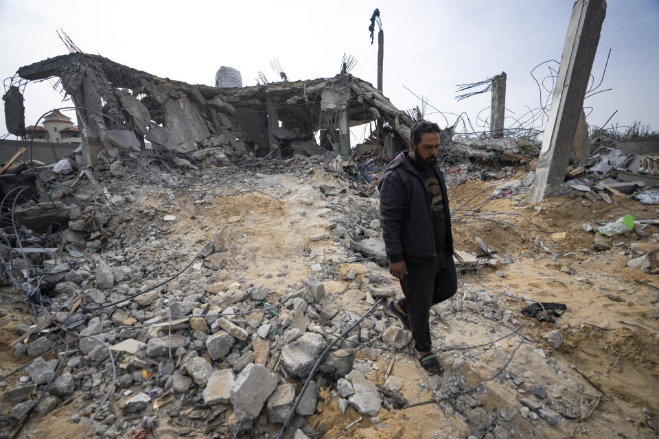 Palestinians look at a house destroyed in an Israeli strike in Rafah, Gaza Strip on Tuesday, March 26, 2024. (AP Photo/Fatima Shbair)
